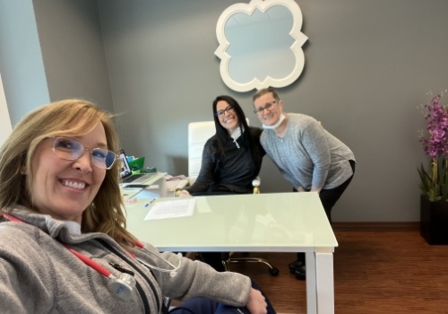 Mesa sleep apnea dentist taking selfie with two team members across desk