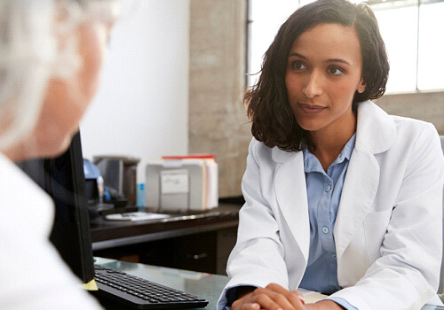 woman speaking to a doctor