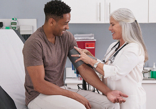 man having his blood pressure taken