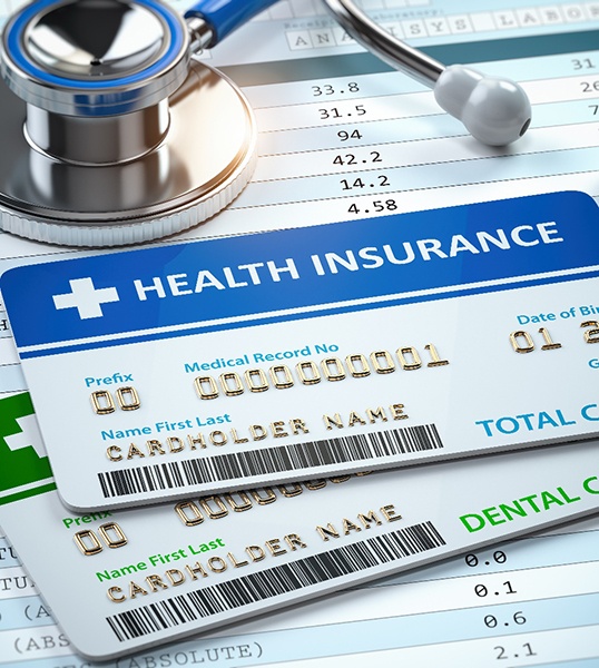 health insurance and dental insurance card on table 