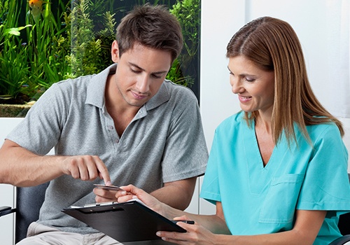 dental professional explaining insurance to patient