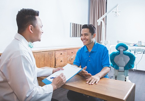 patient talking to dentist about insurance 