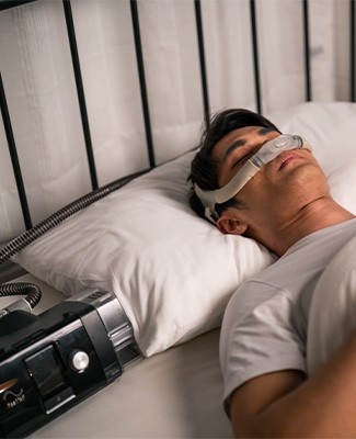 Man wearing a CPAP machine