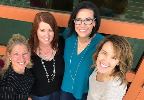 Doctor Layman smiling with three team members at Go to Sleep Center Mesa