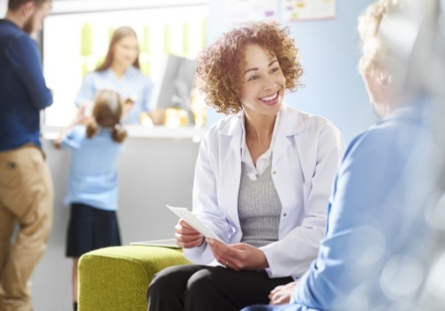 Sleep apnea doctor talking to senior patient