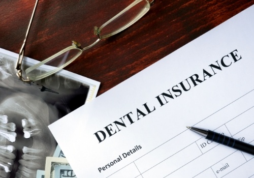 Dental insurance form on dark wooden table