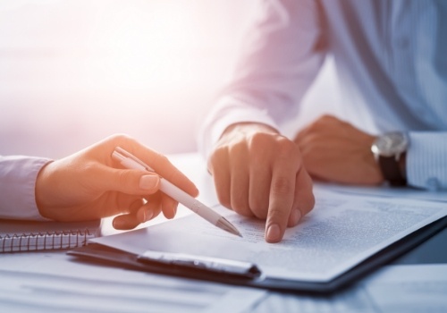 Two people looking at paperwork on clipboard