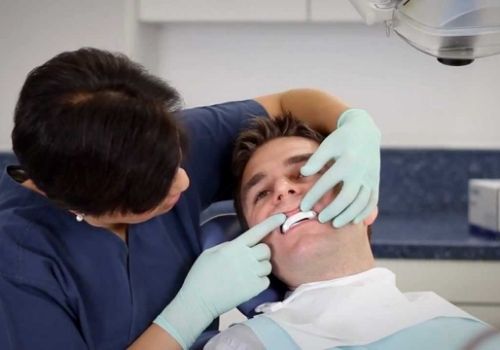 Sleep apnea dentist fitting a patient with an oral appliance