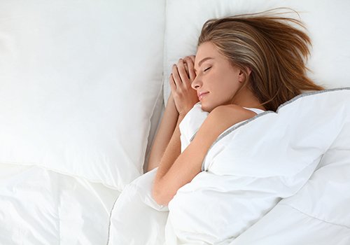 Woman sleeping peacefully in bed